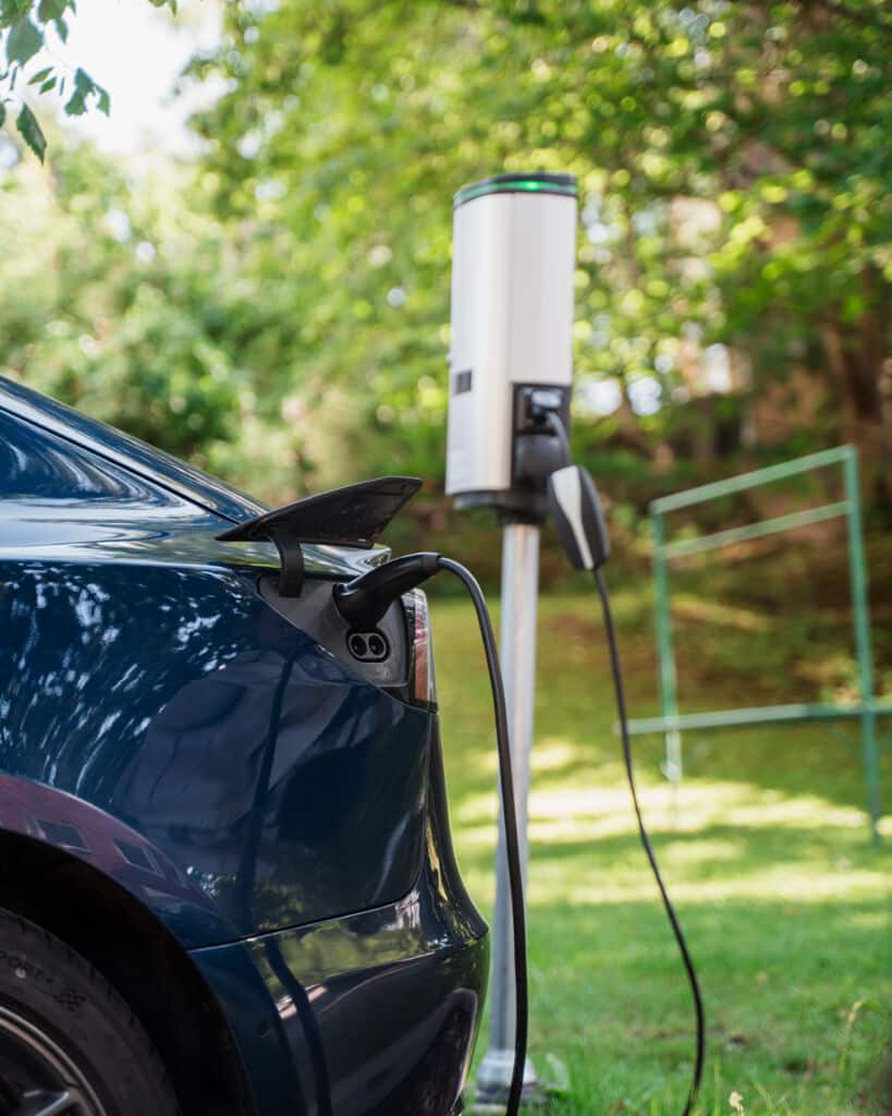 Silver electric car charging at an Elektra EV charging station